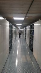 Top Floor of Mezzanine with light shelving behind lockable doors